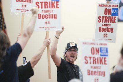 Union members react as Aerospace Machinists District 751 President Jon Holden (out of frame) announces that union members rejected a proposed Boeing contract and will go on strike, following voting results at their union hall in Seattle, Washington, on September 12, 2024. - Boeing workers in the Seattle region overwhelmingly voted to strike on September 12, rejecting a contract the embattled aviation giant characterized as a boon for staff given the company's stressed financial condition. (Photo by Jason Redmond / AFP)