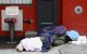 A homeless person sleeps near Madison Square Garden on April 29, 2020 in New York City. New York Citys homeless have sought refuge in the subways to escape the coronavirus pandemic, causing subway workers to ask the city for a solution. New York's new plan calls for police officers and social workers going into stations late night and removing homeless people from the trains and offering them shelter. Subway workers then clean and disinfect cars. (Photo by Angela Weiss / AFP)