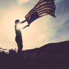 A man waves a US flag.