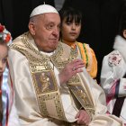 Pope Francis is surrounded by children at the end of the Christmas Eve mass at The St Peter's Basilica in the Vatican on December 24, 2024. - Pope Francis marks Christmas Eve with a special ceremony launching Jubilee 2025, a year of Catholic celebrations set to draw more than 30 million pilgrims to Rome. Over the next 12 months, pilgrims will pass through the large and imposing bronze door, which is normally closed, by tradition benefiting from a "plenary indulgence", a type of forgiveness for their sins. (Photo by Tiziana FABI / AFP)